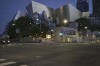a building with large metallic sculptures sitting on the side of it's sides in the middle of a street