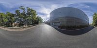 the 360 - view lens photo shows this skateboarder doing a trick on the corner