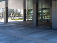 two grey blocks sitting next to a tall building on a sidewalk in front of grass