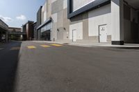 there is a yellow crosswalk at this city area on an empty street near a building