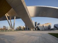 a view of an outside with modern buildings in the background in the foreground is a walkway and walkway