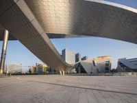 a view of an outside with modern buildings in the background in the foreground is a walkway and walkway