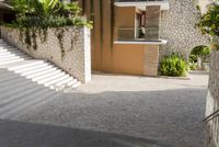 an entrance that has steps and bushes on each side of it with a door opening, a window and plants at the top of one