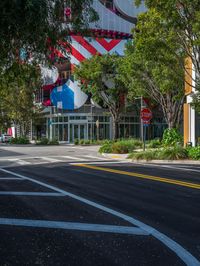 a building with american flag design on top and street signs painted to look like two people riding bicycles