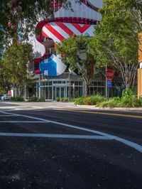 a building with american flag design on top and street signs painted to look like two people riding bicycles