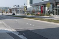 a city street is empty and has buildings lining the street next to it for pedestrians to use