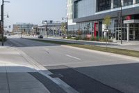 a city street is empty and has buildings lining the street next to it for pedestrians to use