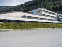 a parking space sits next to a building in the mountainside area of a hotel