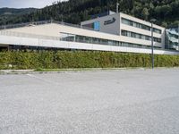 a parking space sits next to a building in the mountainside area of a hotel