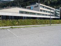 a parking space sits next to a building in the mountainside area of a hotel