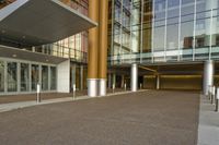 an entrance way that shows the entrance of the building with no doors, and the sidewalk is empty