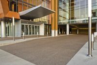 an entrance way that shows the entrance of the building with no doors, and the sidewalk is empty