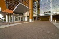 an entrance way that shows the entrance of the building with no doors, and the sidewalk is empty