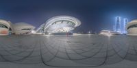 a picture of a circular object that is in the shape of a building at night