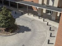 a school courtyard features concrete, trees and benches for students to use in the day