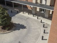 a school courtyard features concrete, trees and benches for students to use in the day