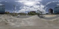 a skateboarder does a trick in the air at the skate park park in a city