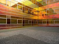 a large building with multi colored windows and a black floor inside of it in front of the sky