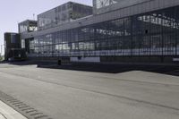 an empty road is next to some buildings and a traffic light in front of it