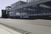 an empty road is next to some buildings and a traffic light in front of it