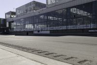 an empty road is next to some buildings and a traffic light in front of it