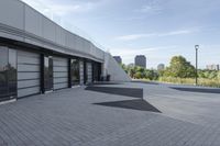 a view of an outside area of an office building with large windows and a circular driveway