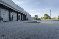 a view of an outside area of an office building with large windows and a circular driveway