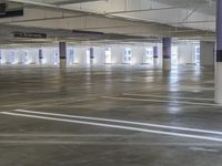 the empty parking garage is full of empty spaces for vehicles to park and get out