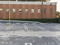 parking lots with white and red paint on them, surrounded by buildings and landscaping area