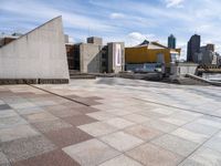 the paved plaza area has an unusual shape and is very clean with no one around