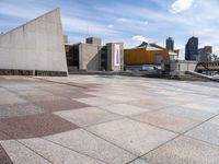 the paved plaza area has an unusual shape and is very clean with no one around