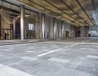 empty building with floor and columns and an open entrance way in front of the building