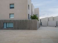 empty area outside concrete building with no people or vehicles at the entrance to area behind it