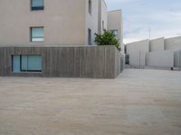 empty area outside concrete building with no people or vehicles at the entrance to area behind it