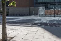 a park bench sits in the middle of a large empty courtyard in a city park