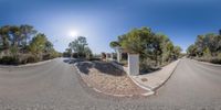 a double view street through the spherical perspective lens shows an entrance way to a town