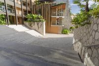 the stairs lead up to an apartment building, which appears to be on a hillside side