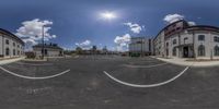 this is a panoramic image of some buildings in front of a parking lot