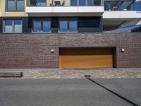 a house that has a yellow garage door in front of it in a city street