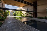 the courtyard features a small pool and outdoor areas that also offer privacy and shade from the sun