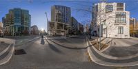 a 360 - fisheye shot of the intersection of streets and buildings in a city