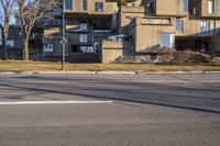 this is a close up shot of the street corner in front of buildings with a stoplight on it