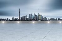 empty room with cityscape in the background with spotlight lighting up to the sky