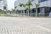 a paved road leading to modern architecture in the city center of singapore, asia and southeast asia