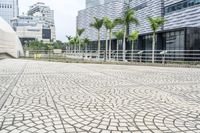 a paved road leading to modern architecture in the city center of singapore, asia and southeast asia