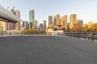 an empty parking lot with a city view in the background, with buildings on both sides