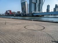 a bicycle is sitting on brick floor in front of city buildings at the beach area