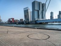 a bicycle is sitting on brick floor in front of city buildings at the beach area