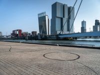 a bicycle is sitting on brick floor in front of city buildings at the beach area