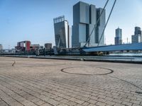 a bicycle is sitting on brick floor in front of city buildings at the beach area